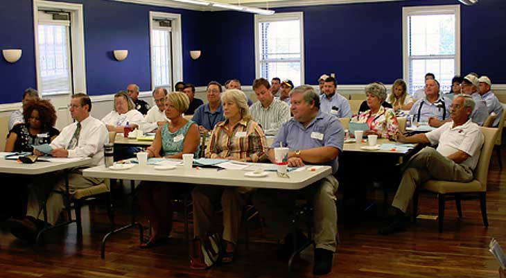 People sitting at tables in conference room