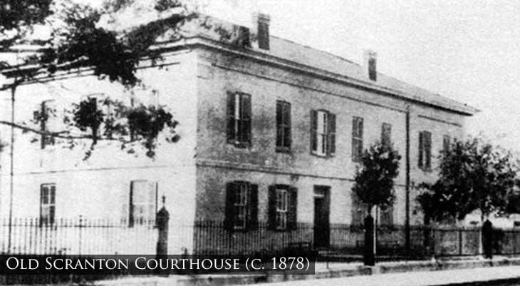 Black and white image of a two story building