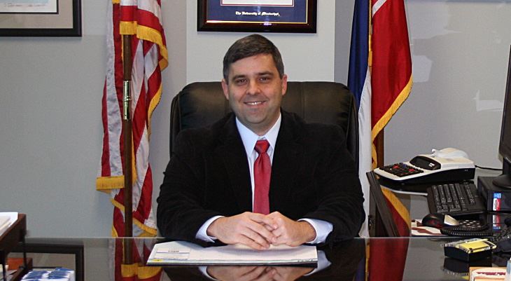 Troy Ross sitting behind desk